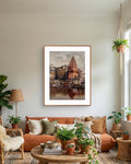 Living room with a framed art of a varanasi ghat and temple painting on the wall